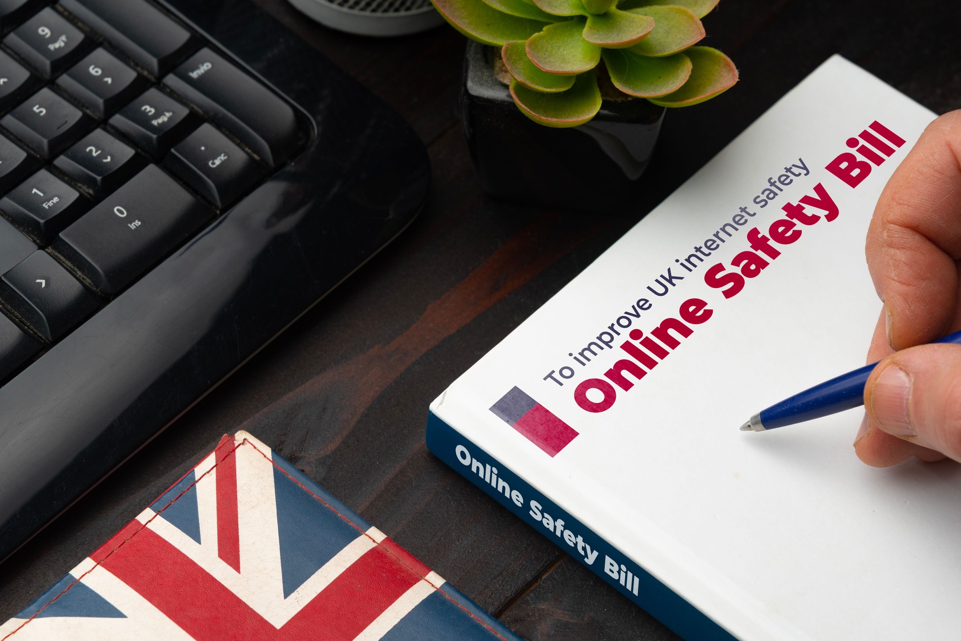Online Safety Bill UK concept: man about to sign the new safety bill for the United Kingdom